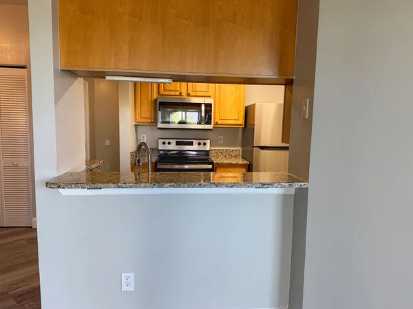 a kitchen with a counter top space and stainless steel appliances