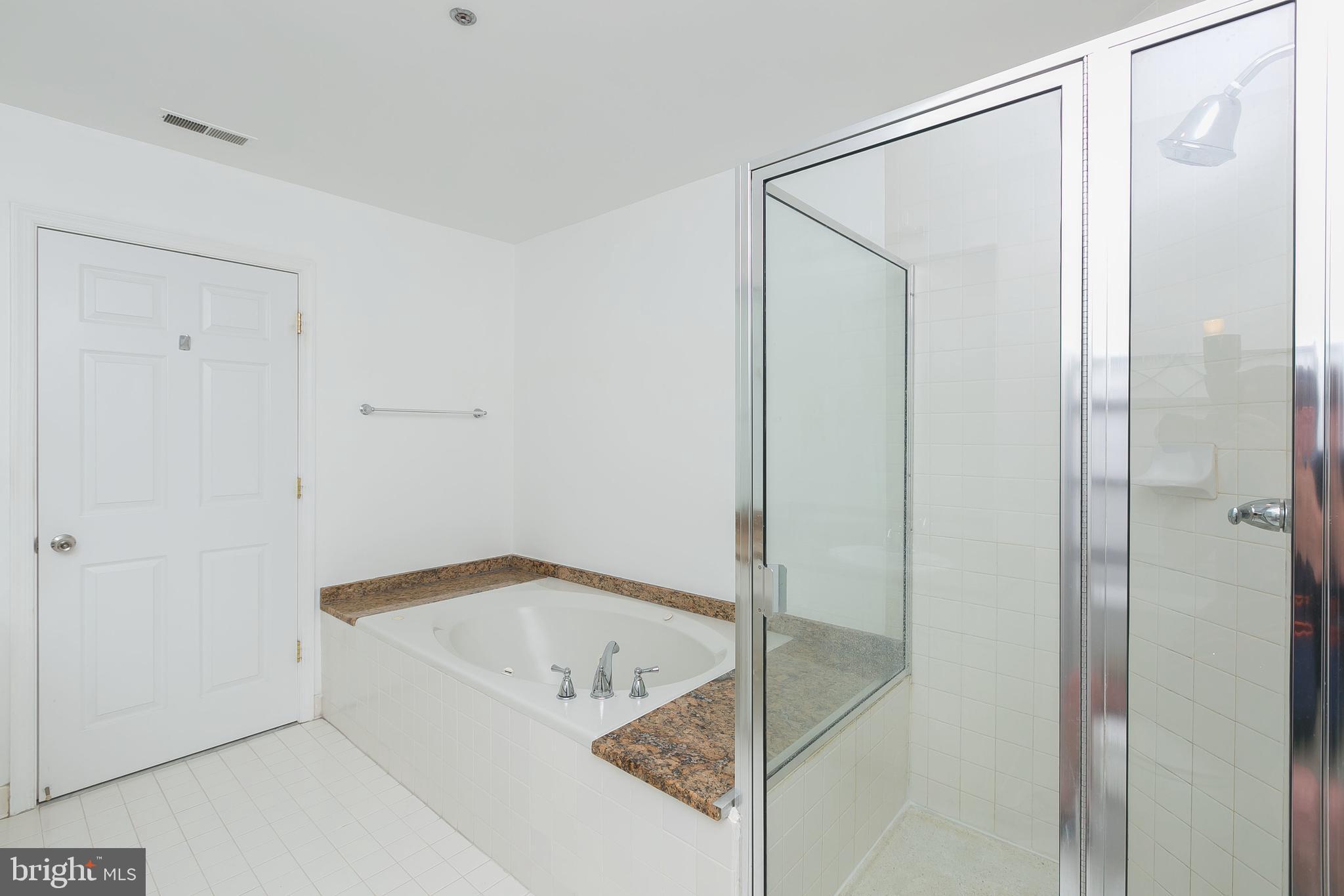 100 Harborview Drive, Unit 513 Baltimore, MD 21230 - Photo 20 of 58 a bathroom with a tub and shower