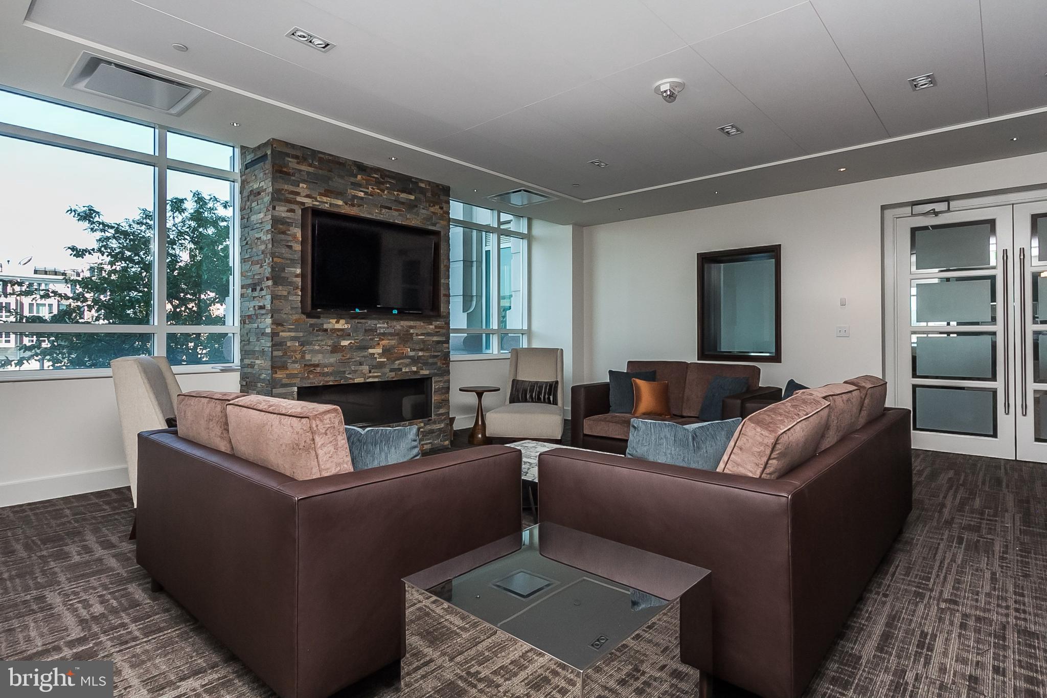 100 Harborview Drive, Unit 513 Baltimore, MD 21230 - Photo 37 of 58 a living room with fireplace furniture and a flat screen tv