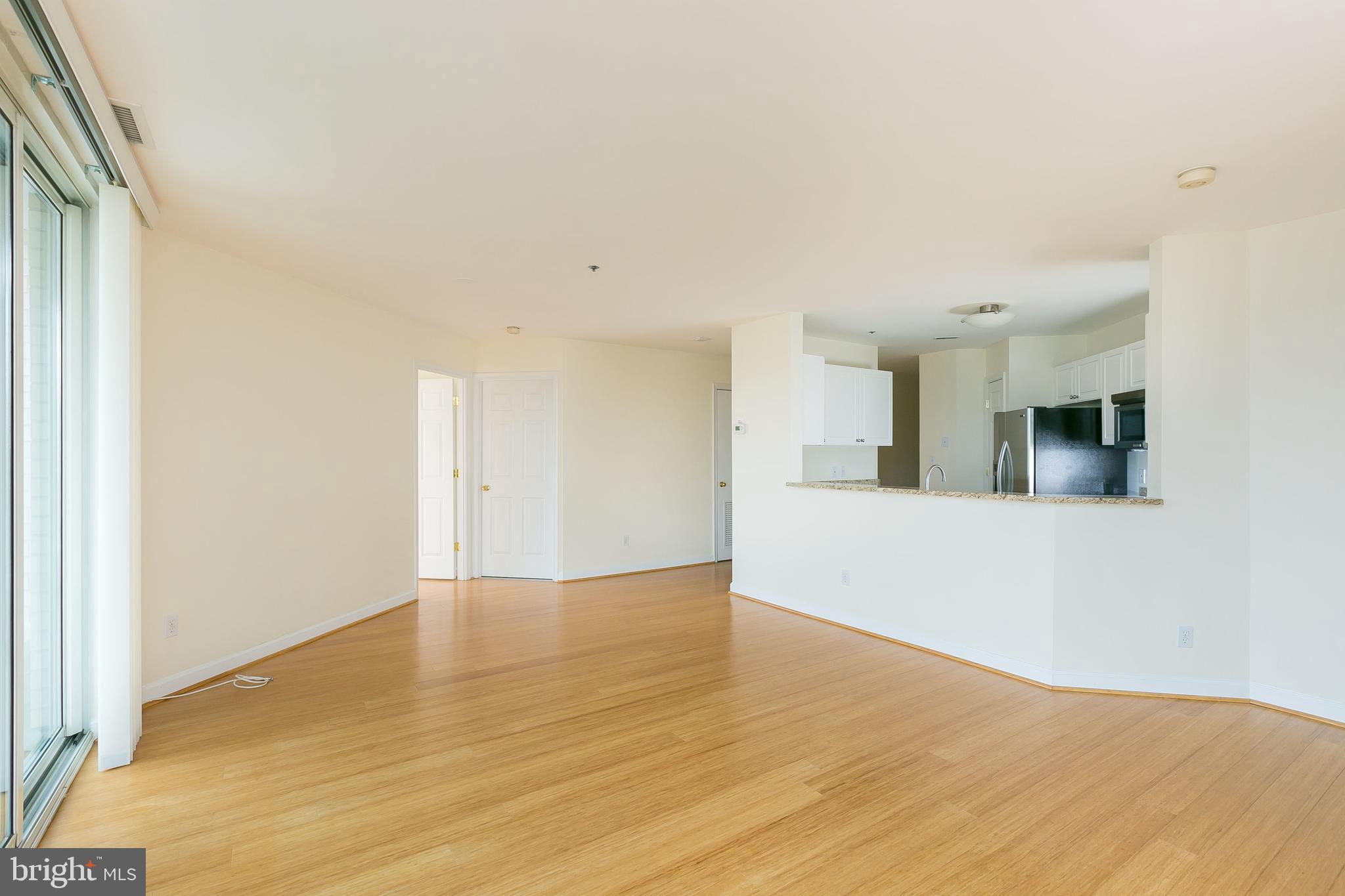 100 Harborview Drive, Unit 513 Baltimore, MD 21230 - Photo 9 of 58 a view of an empty room with wooden floor