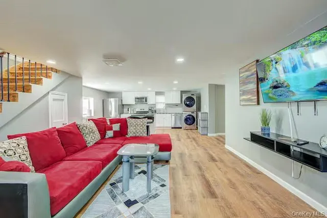 a living room with furniture and kitchen view