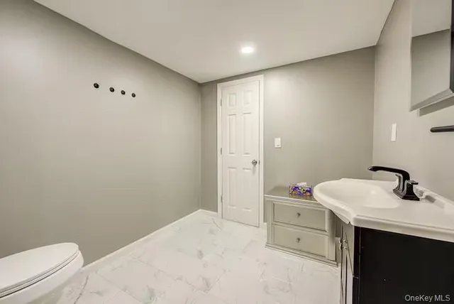 a bathroom with a sink toilet vanity and tub