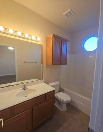 a bathroom with a sink a toilet a mirror and vanity