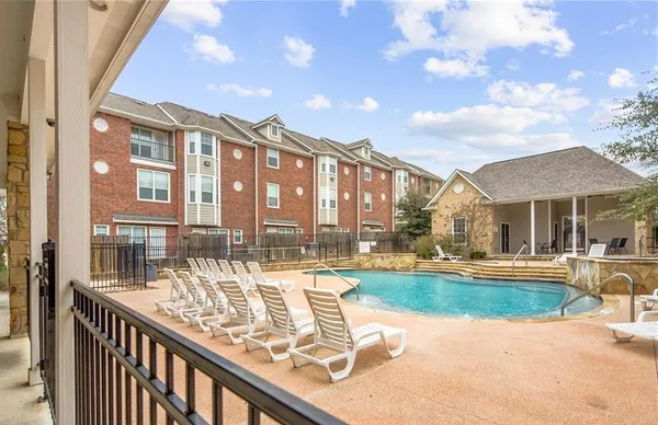 a view of a swimming pool with a lounge chairs