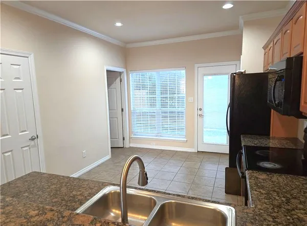 a kitchen with a sink a refrigerator and a window