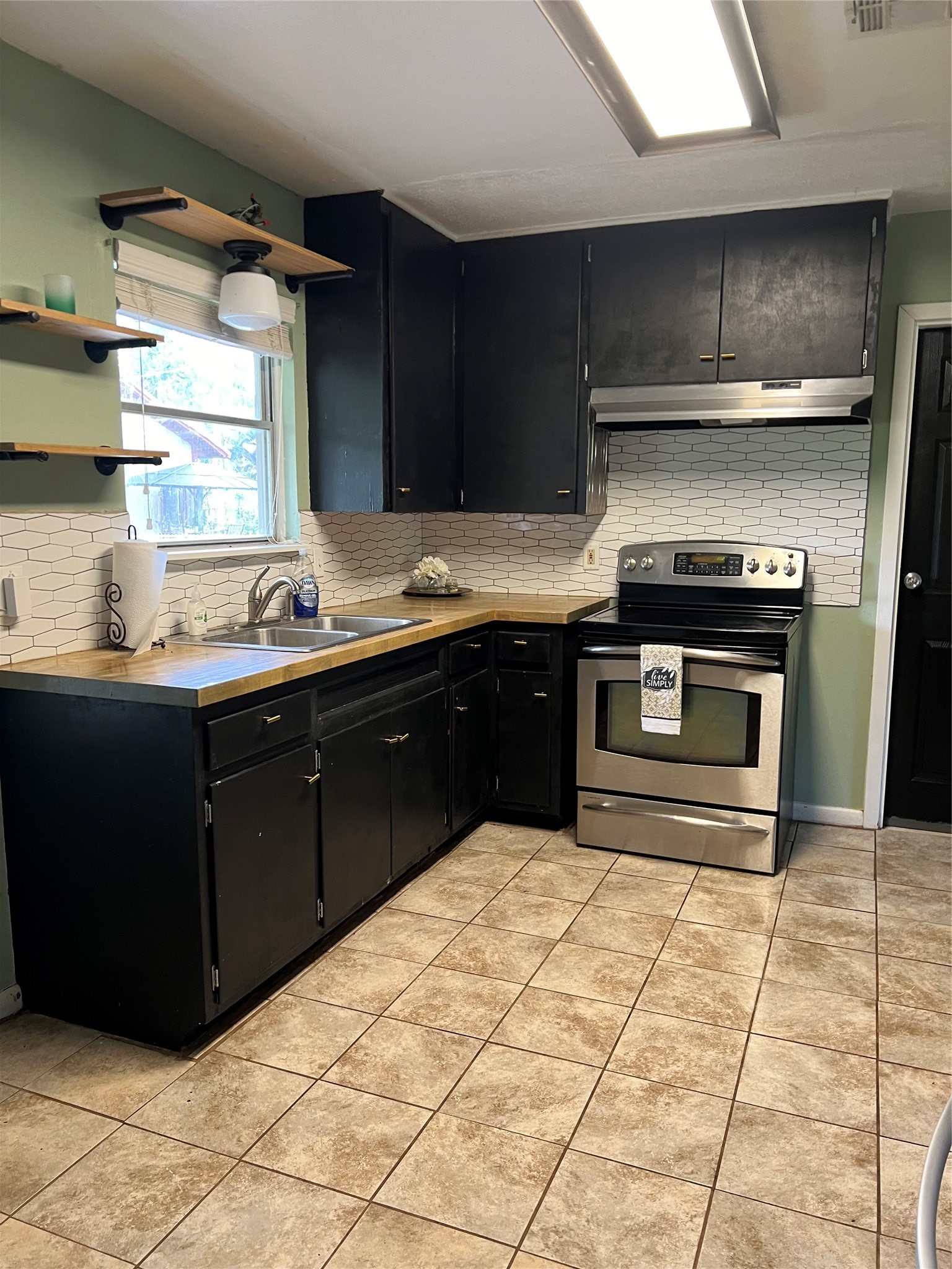 1105 Earley Street Sweeny, TX 77480 - Photo 6 of 12 a kitchen with stainless steel appliances granite countertop a stove a sink and a microwave