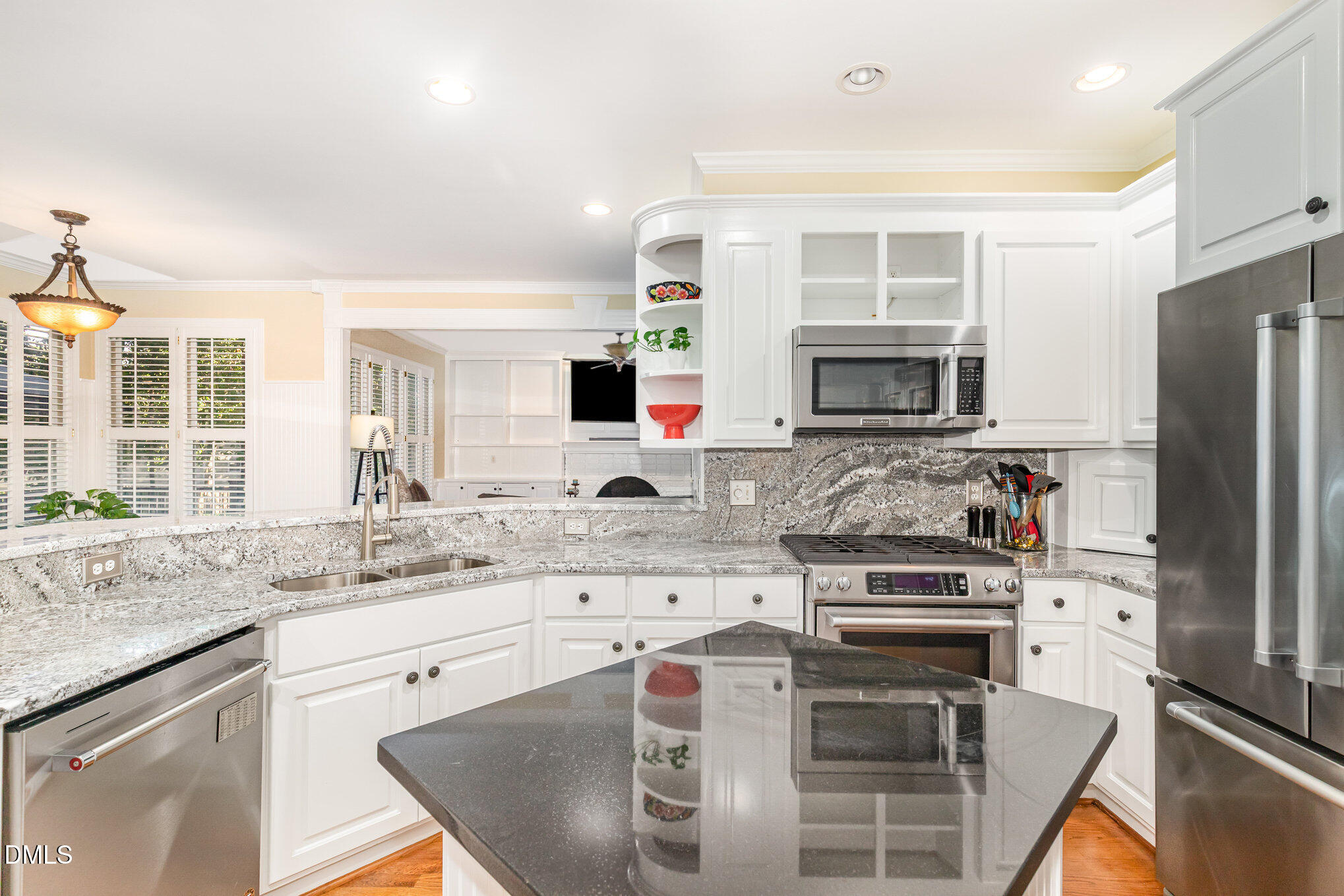 8700 Aldersgate Way Raleigh, NC 27615 - Photo 12 of 34 a kitchen with kitchen island granite countertop a stove sink and microwave