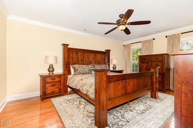 a bed room with a bed and a ceiling fan
