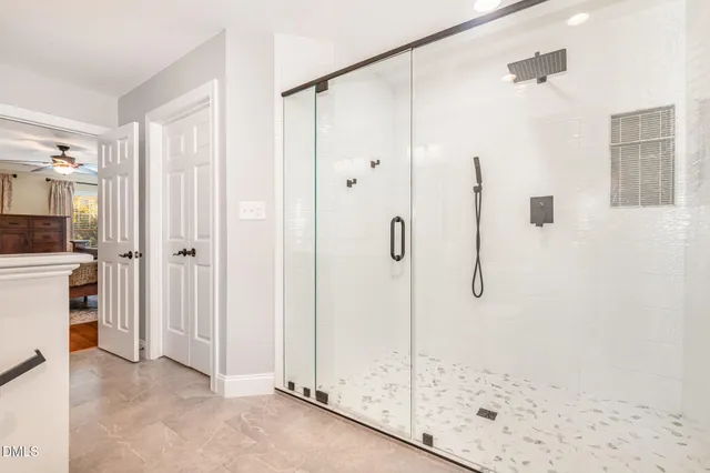 a bathroom with a shower and a glass door