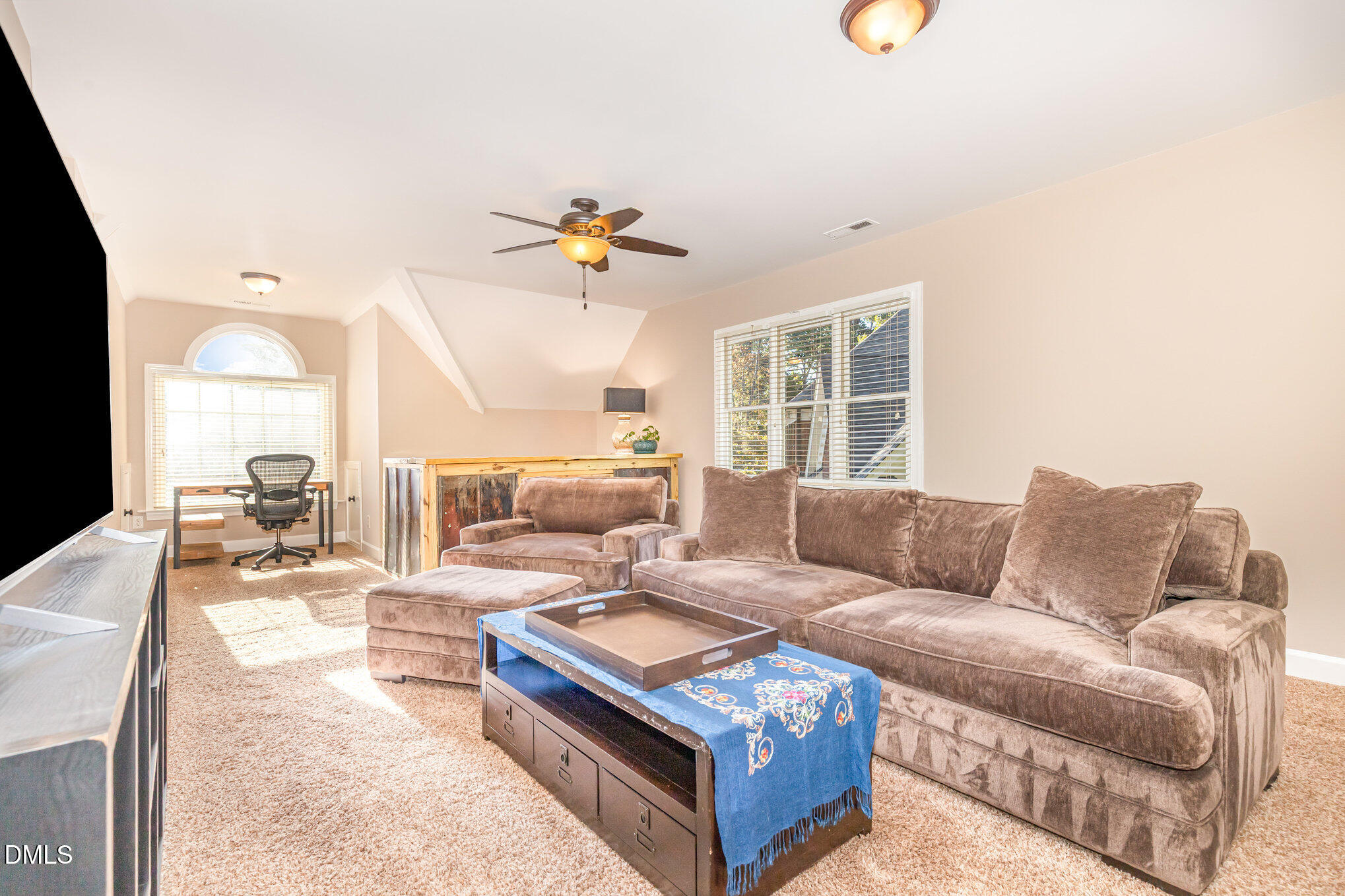 8700 Aldersgate Way Raleigh, NC 27615 - Photo 22 of 34 a living room with furniture a fireplace and a flat screen tv