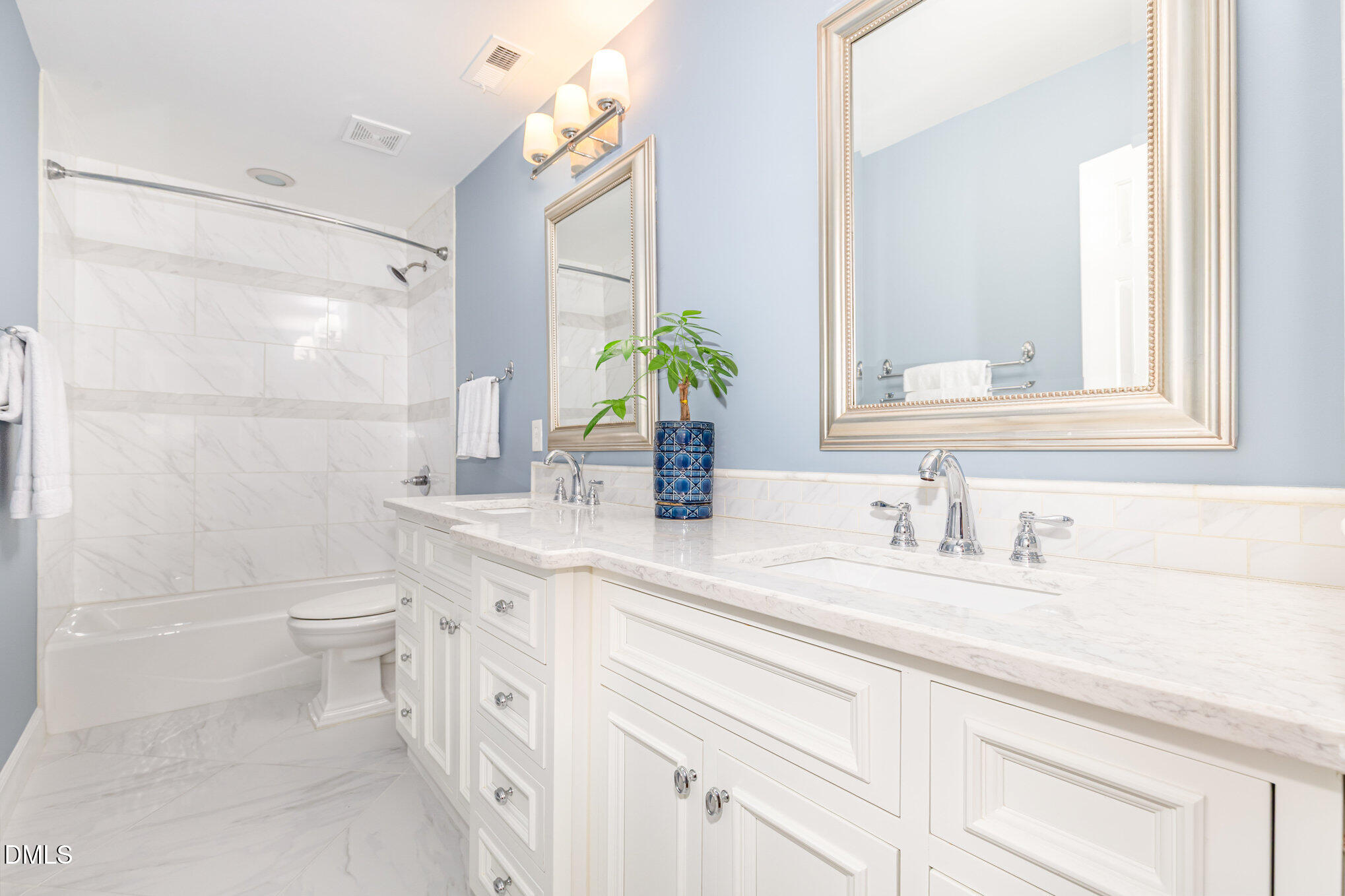 8700 Aldersgate Way Raleigh, NC 27615 - Photo 23 of 34 a bathroom with a double vanity sink toilet and shower