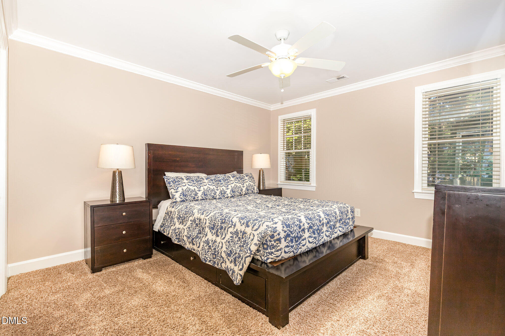 8700 Aldersgate Way Raleigh, NC 27615 - Photo 25 of 34 a bed sitting in a bedroom next to a window and a chandelier