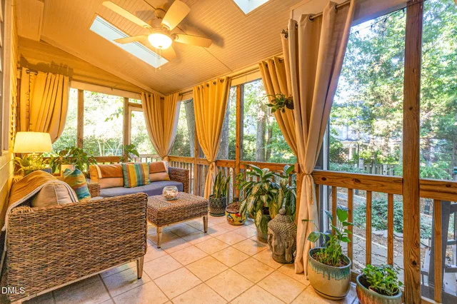 a bedroom with furniture and large windows