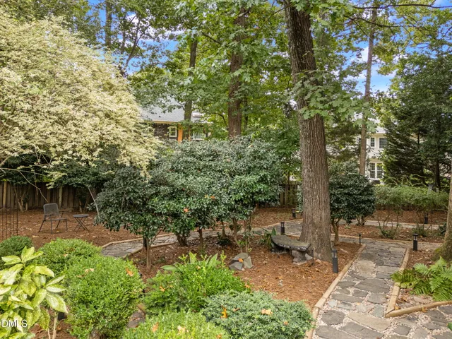 a backyard of a house with table and chairs