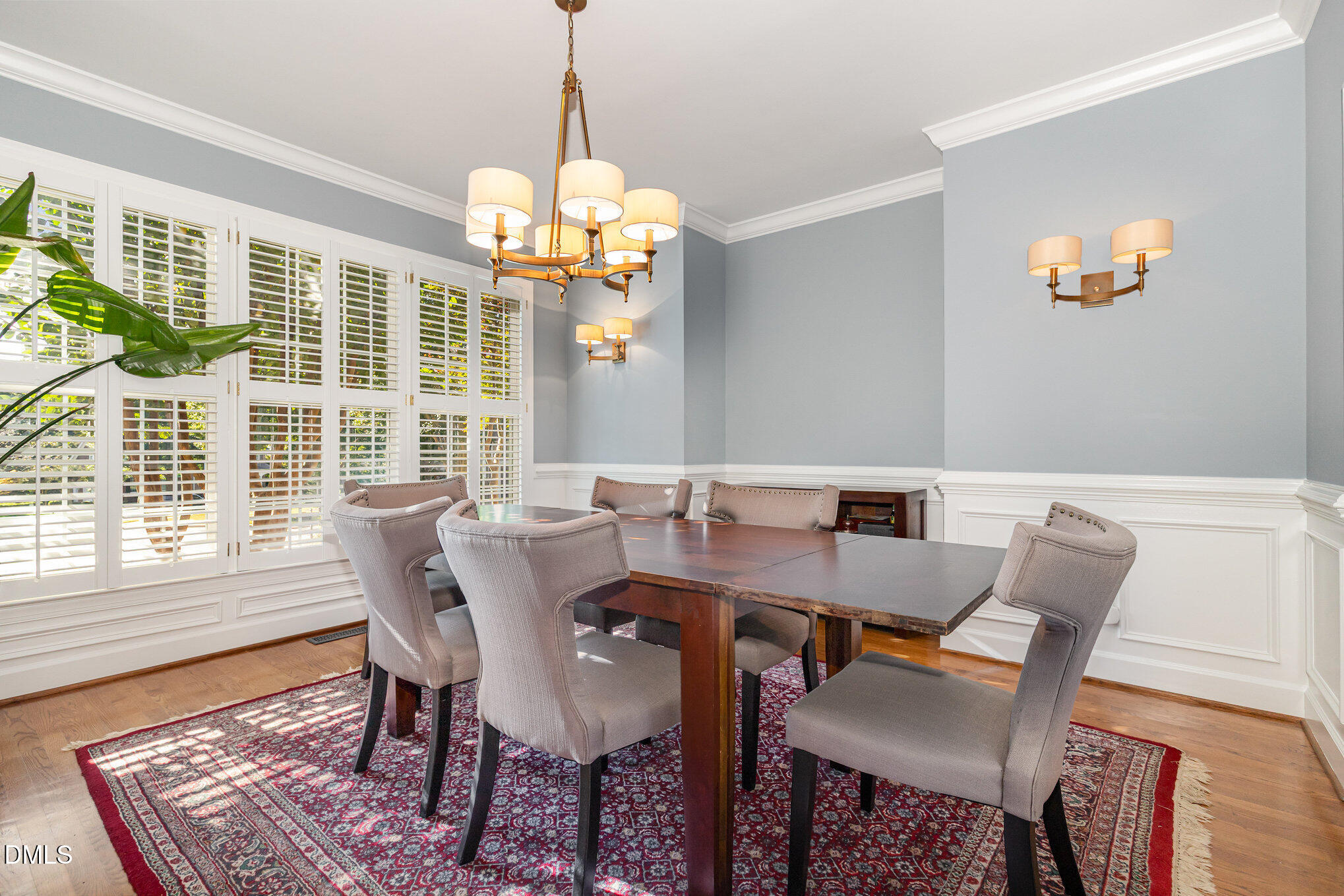 8700 Aldersgate Way Raleigh, NC 27615 - Photo 5 of 34 a view of a dining room with furniture a chandelier and wooden floor