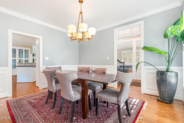 a view of a dining room with furniture and chandelier