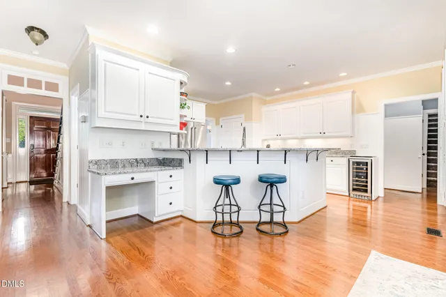 a kitchen with stainless steel appliances granite countertop a stove top oven a sink a counter space and cabinets