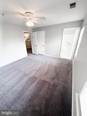 an empty room with a mirror and a window