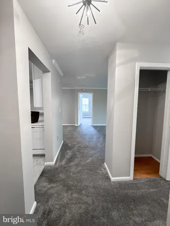 a view of entryway and hall with a chair