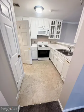 a kitchen with a stove a sink and a refrigerator