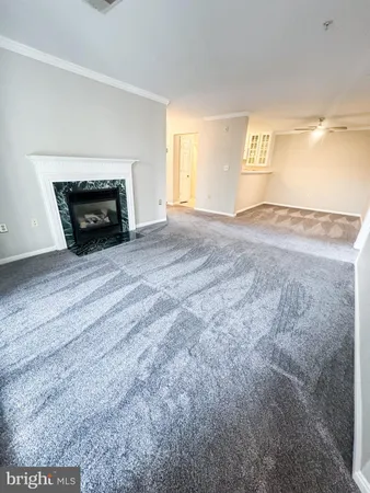 a view of empty room with a fireplace and a window