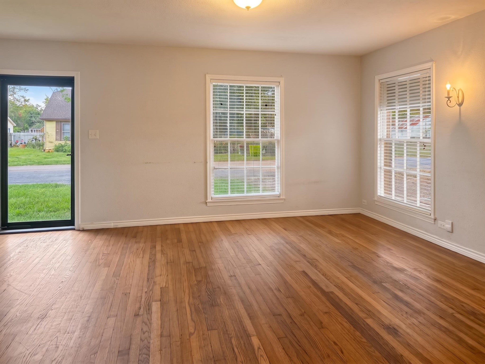 2313 Avenue L Rosenberg, TX 77471 - Photo 5 of 31 Bright and inviting living room with large windows that provide abundant natural light and views of the front yard.
