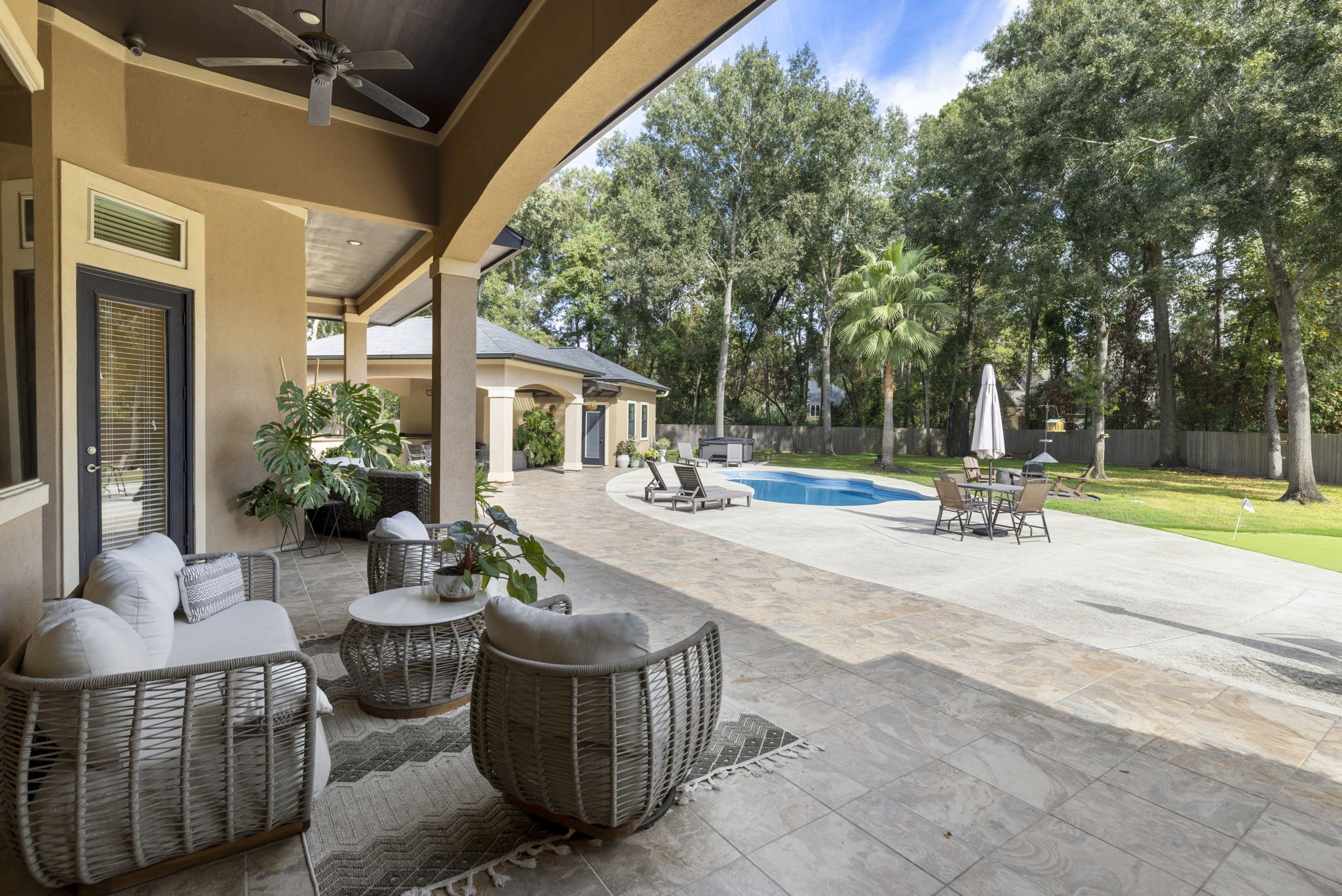4103 Tee Tree Court Spring, TX 77386 - Photo 29 of 37 Expansive covered back patio provides a front-row seat to the backyard! Wood-paneled ceiling, fans, and built-in speakers make this a great extension of the indoor living space.
