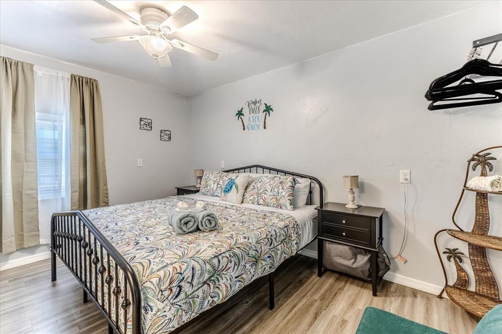 5261 Circle Drive Weeki Wachee, FL 34607 - Photo 33 of 49 a bedroom with a bed and a chandelier