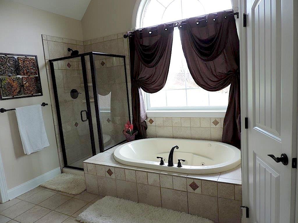 1145 Mohawk Road McDonald, PA 15057 - Photo 17 of 24 1145 Mohawk Road Resort Style Master Bath - Features an oversized ceramic shower stall, tub, & granite tops, neutral wall tone & flooring, large windows, commode
