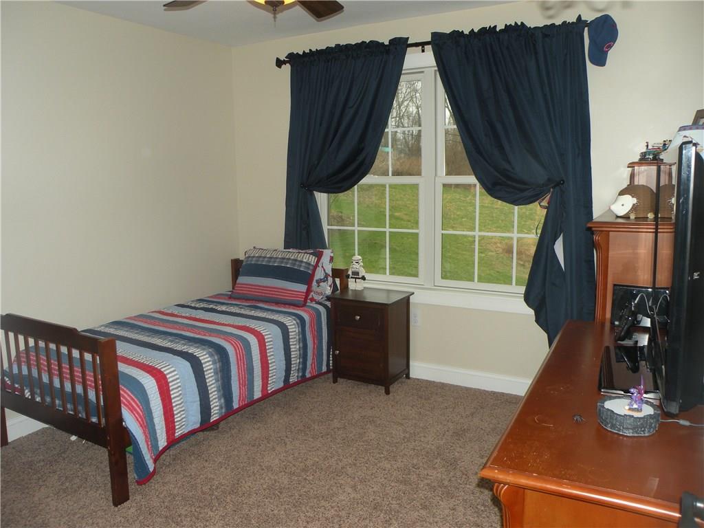 1145 Mohawk Road McDonald, PA 15057 - Photo 20 of 24 1145 Mohawk Road Bedroom 3- Neutral wall tone, neutral carpeting, ceiling fan with light, large window