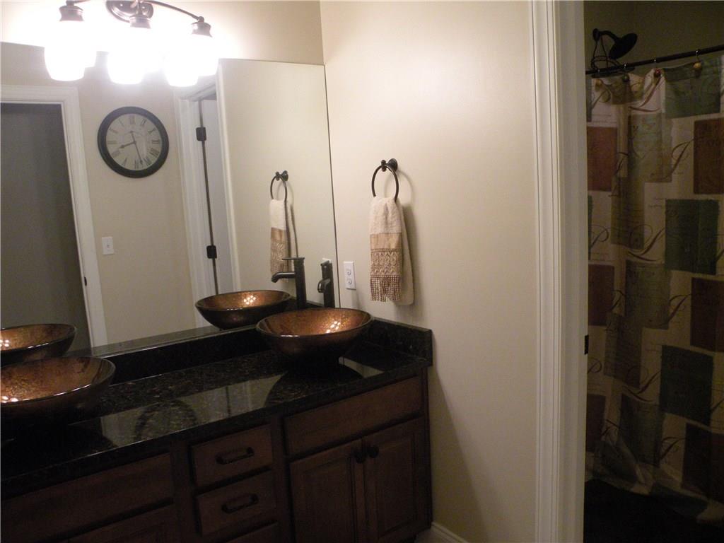 1145 Mohawk Road McDonald, PA 15057 - Photo 21 of 24 1145 Mohawk Road Full Hall Bath - Neutral wall tone, large custom sink with vanity and large mirror, custom lighting, shower with bath, commode