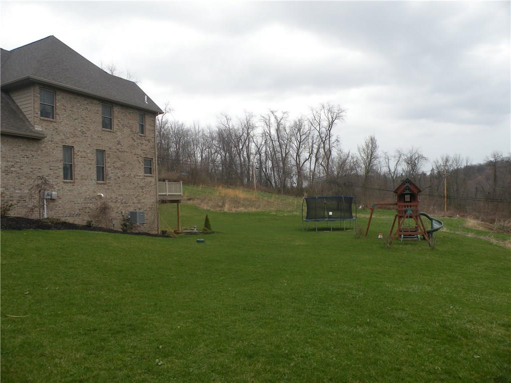 1145 Mohawk Road McDonald, PA 15057 - Photo 24 of 24 1145 Mohawk Road Rear Yard - Spacious 2 car attached garage, level concrete driveway & walk, large rear deck overlooking the great yard!