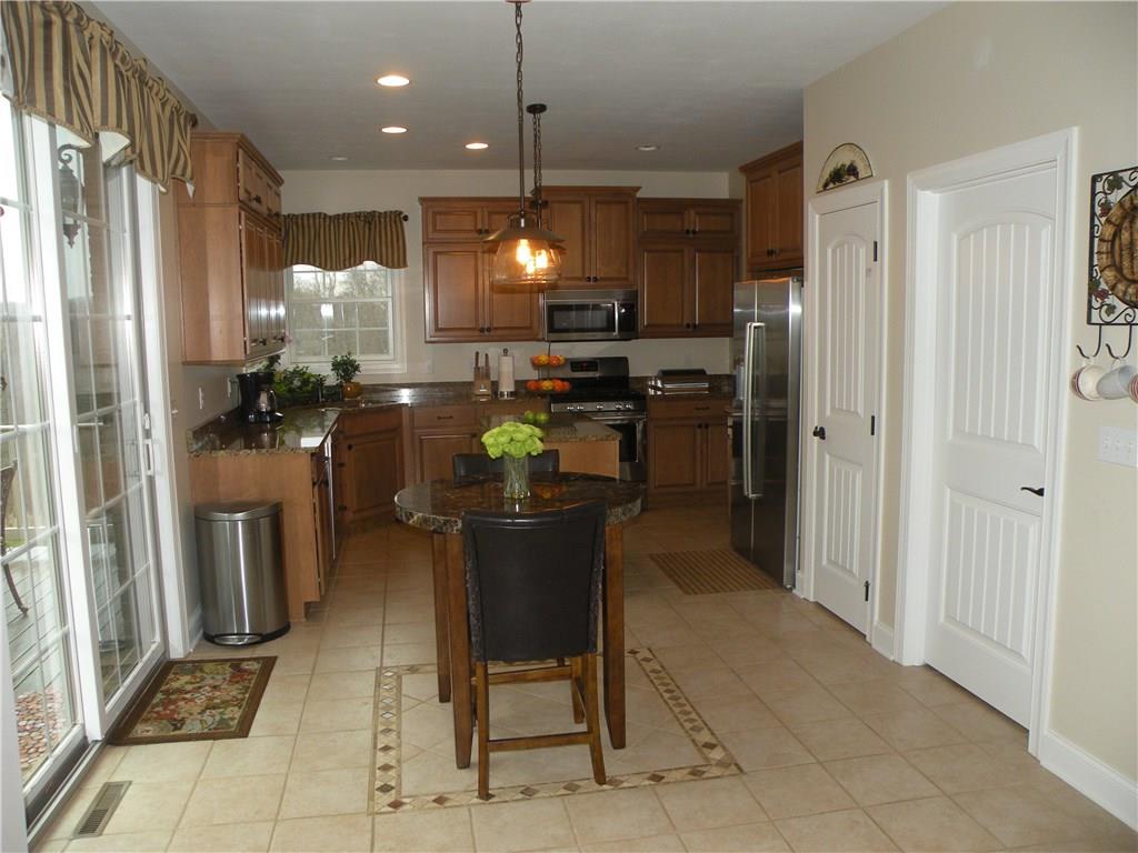 1145 Mohawk Road McDonald, PA 15057 - Photo 6 of 24 1145 Mohawk Road Gourmet Center Island Eat-In Kitchen - Boasting granite tops & stainless appliances, neutral wall tone, neutral flooring, large windows, custom lighting