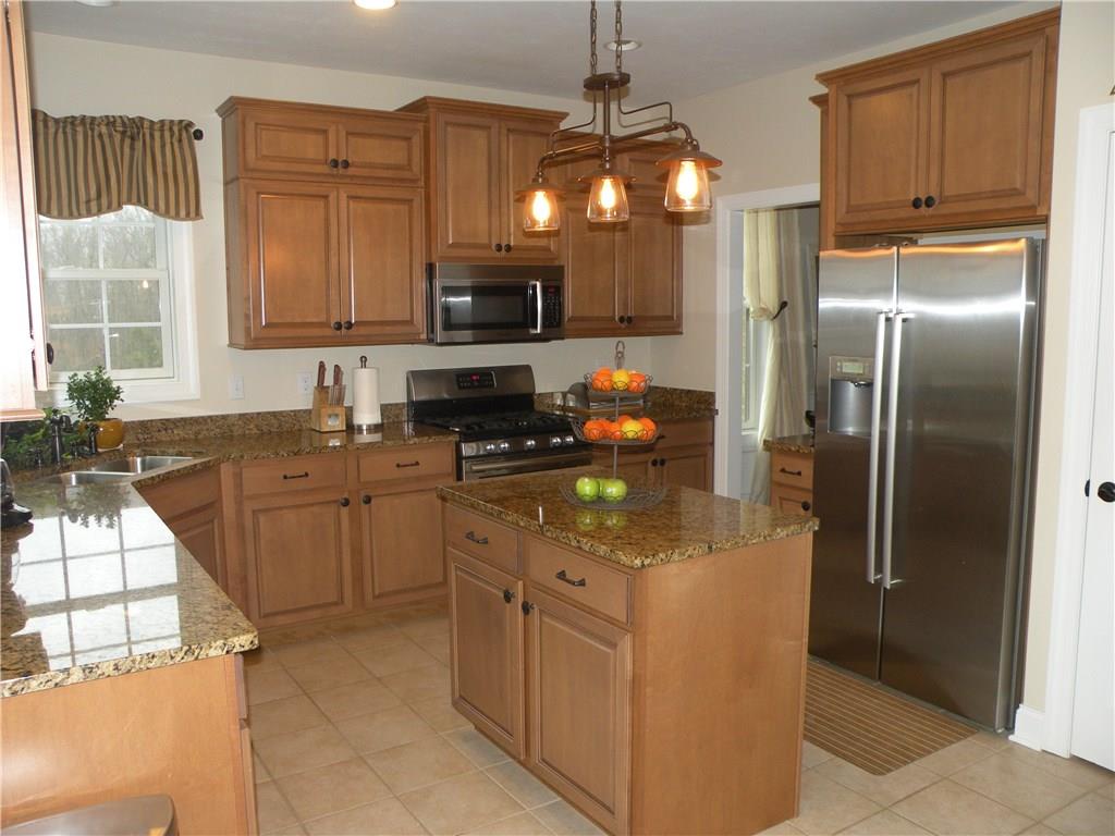 1145 Mohawk Road McDonald, PA 15057 - Photo 7 of 24 1145 Mohawk Road Gourmet Center Island Eat-In Kitchen - Boasting granite tops & stainless appliances, neutral wall tone, neutral flooring, large windows, custom lighting