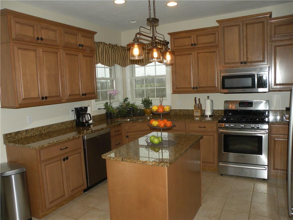 1145 Mohawk Road McDonald, PA 15057 - Photo 9 of 24 1145 Mohawk Road Gourmet Center Island Eat-In Kitchen - Boasting granite tops & stainless appliances, neutral wall tone, neutral flooring, large windows, custom lighting