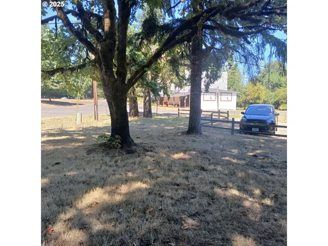 a view of swimming pool with outdoor seating and trees in the background
