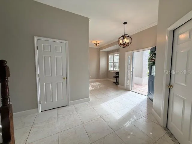 a view of a hallway with wooden floor and windows