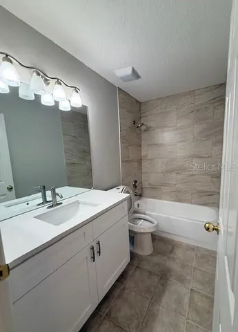 a bathroom with a double vanity sink toilet and shower