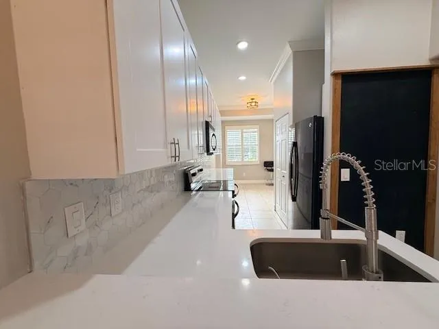 a large room with a lot of large mirror and a window