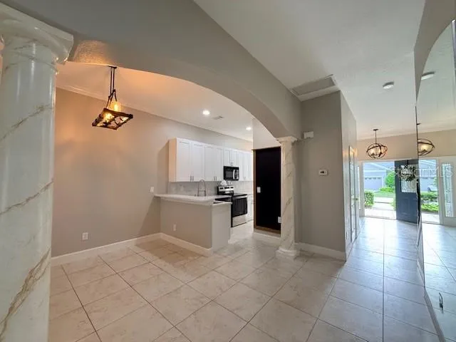 a view of a kitchen with a sink and a refrigerator