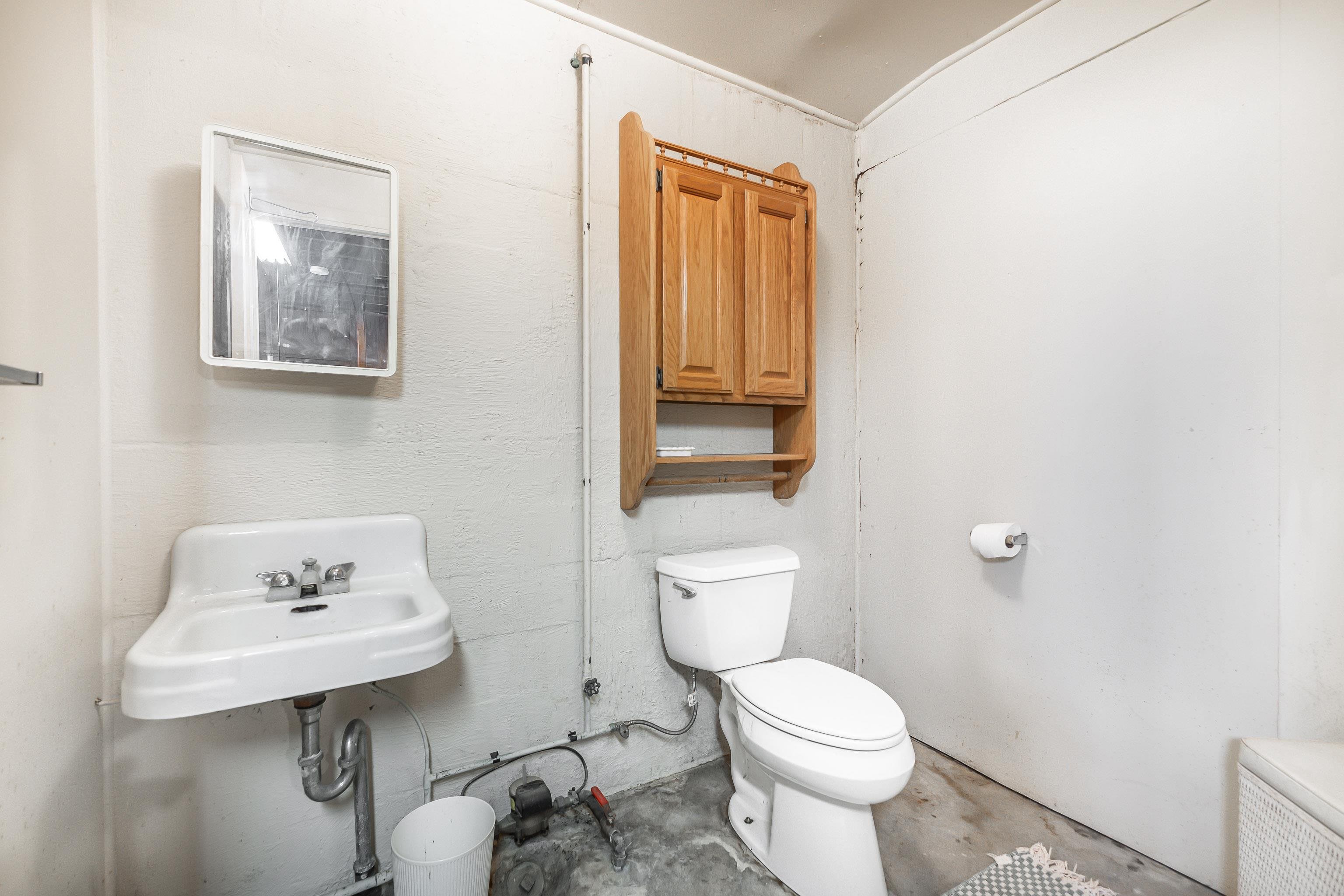 319 East Catlin Street Elizabeth, IL 61028 - Photo 18 of 26 a white toilet sitting next to a bathroom sink