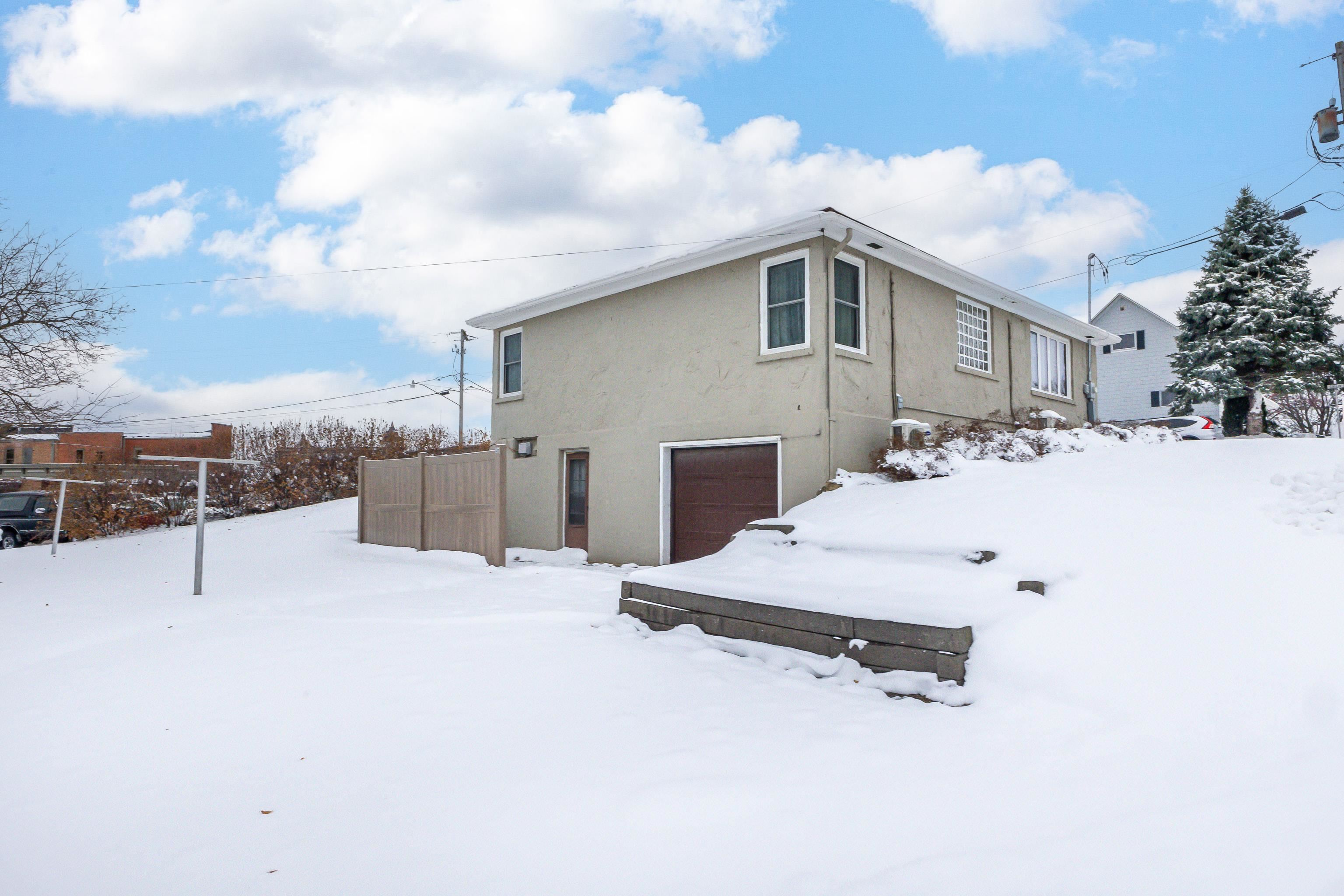 319 East Catlin Street Elizabeth, IL 61028 - Photo 23 of 26 a view of a house with a snow in the background