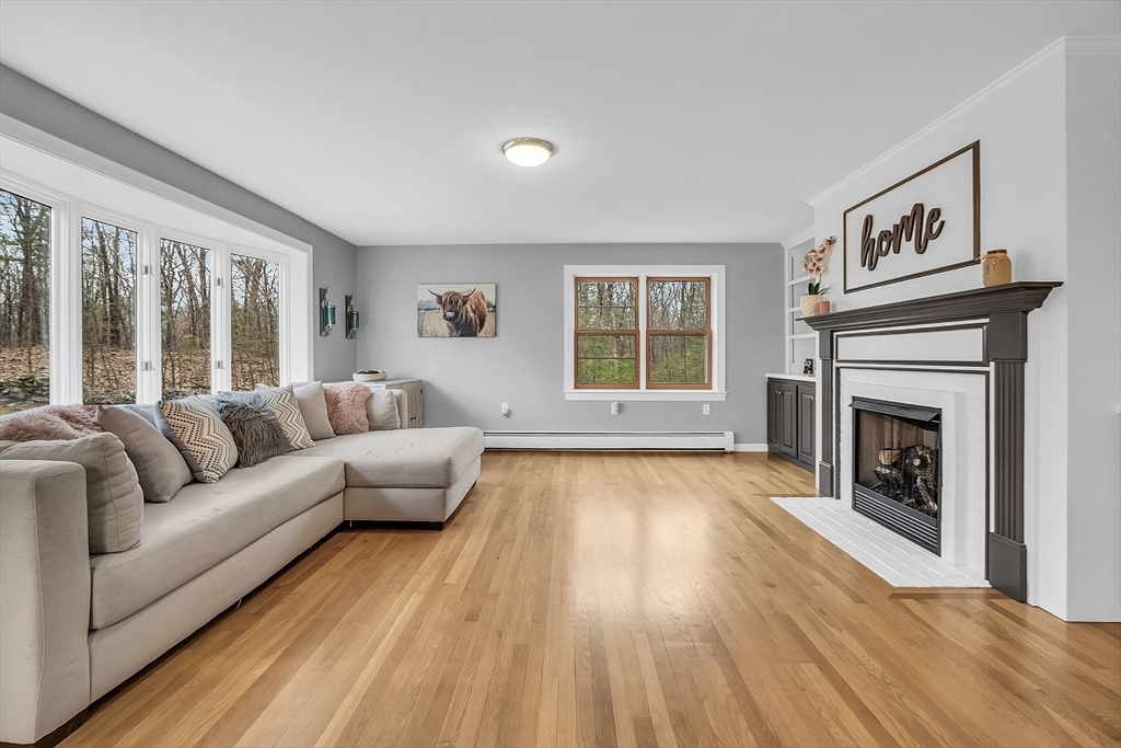 79 Tyler Road Townsend, MA 01469 - Photo 11 of 41 a living room with furniture and a fireplace