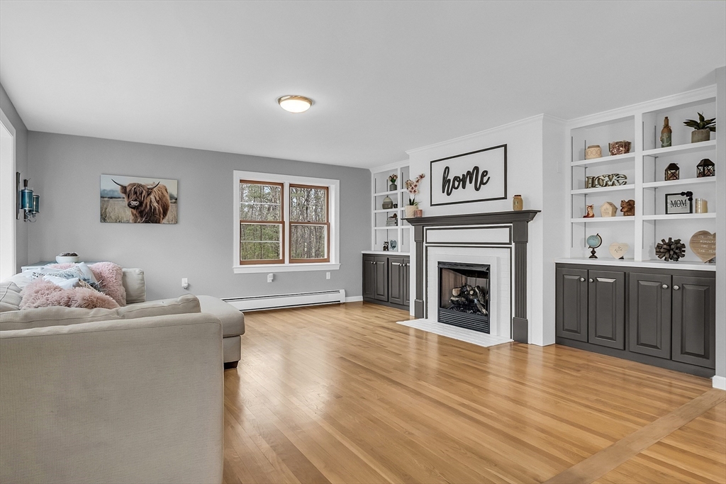 79 Tyler Road Townsend, MA 01469 - Photo 12 of 41 a living room with furniture and a fireplace