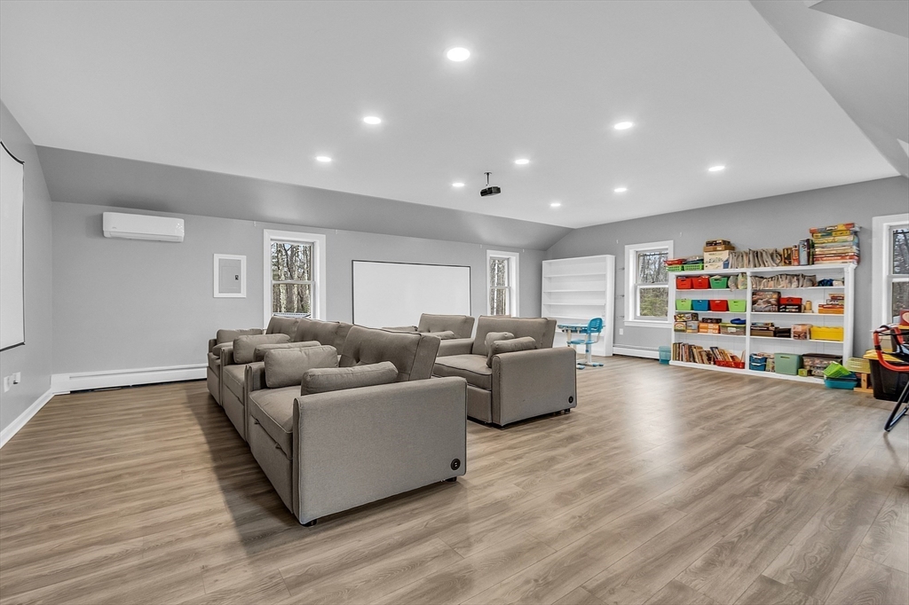 79 Tyler Road Townsend, MA 01469 - Photo 16 of 41 a living room with furniture and a flat screen tv