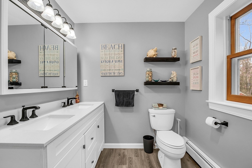 79 Tyler Road Townsend, MA 01469 - Photo 19 of 41 a bathroom with a toilet sink and mirror