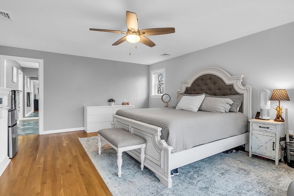 79 Tyler Road Townsend, MA 01469 - Photo 20 of 41 a bedroom with a bed and a chandelier