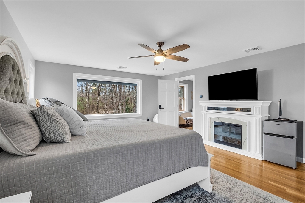 79 Tyler Road Townsend, MA 01469 - Photo 21 of 41 a spacious bedroom with a large bed and a flat screen tv