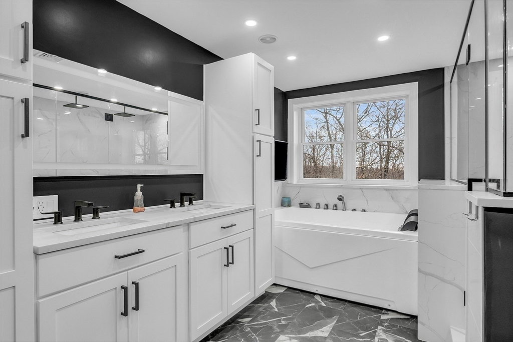 79 Tyler Road Townsend, MA 01469 - Photo 22 of 41 a bathroom with a double vanity sink a mirror and a bathtub