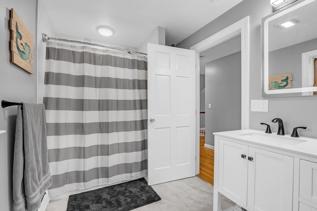 79 Tyler Road Townsend, MA 01469 - Photo 27 of 41 a bathroom with a sink a mirror a toilet and a shower